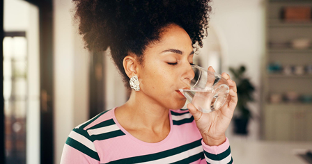 How to Build a Stress-Free Morning Routine 6 Woman drinking water and glass in the morning